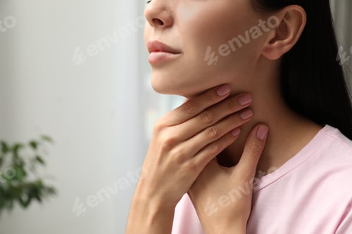 Preview: Young woman doing thyroid self examination indoors, closeup. Space for text