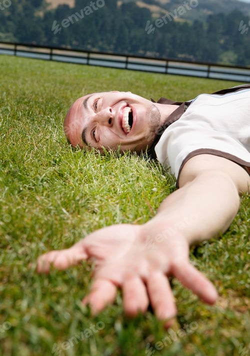Preview: Happy man lying on the grass