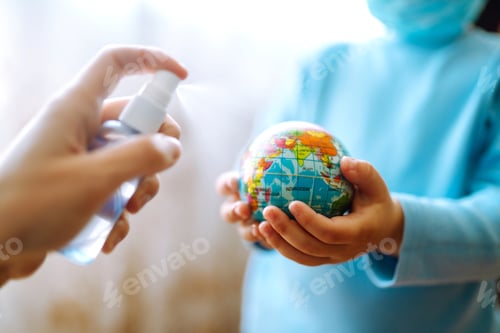 Preview: Planet sterilization. Child in protective sterile medical mask holding a world globe. Save planet.