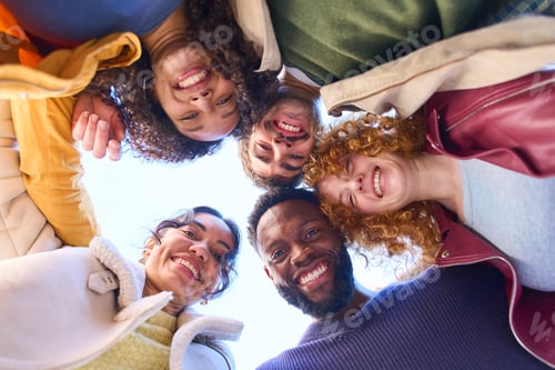 Preview: Happy multi ethnic friends forming a circle and smiling