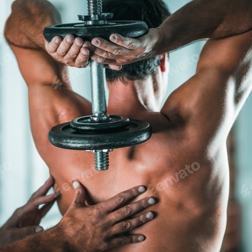 Preview: Peronal trainer with male client in the gym