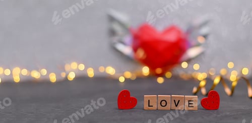 Preview: the words LOVE are made of wooden cubes with red hearts.