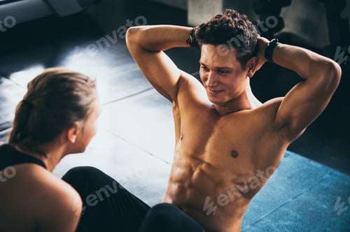 Preview: Personal trainer helping woman exercising in the sport gym