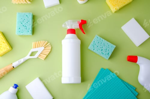 Preview: White spray bottle with sponges and brush on green surface for cleaning home