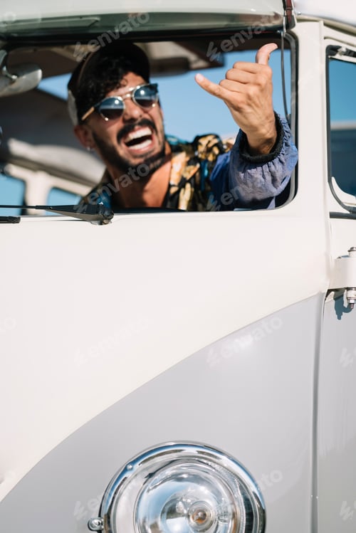 Preview: Man showing tongue and gesturing in van