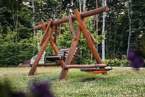 Preview: Wooden backyard swing set with natural surroundings, emphasizing relaxation, outdoor activities