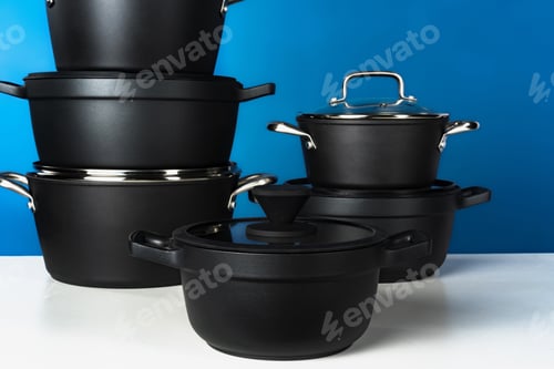 Preview: Set of black cookware against blue background