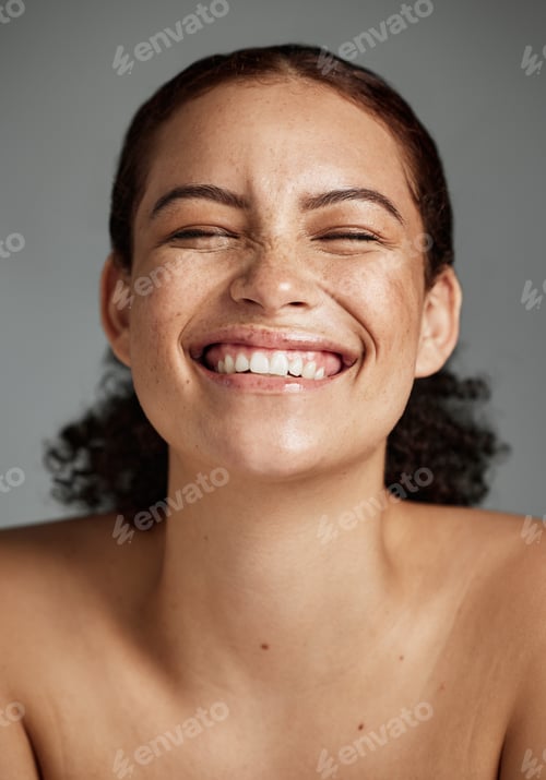 Preview: Face, beauty and funny with a model black woman in studio on a gray background laughing for skincar