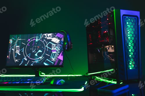Preview: Composite of computer, keyboard with video game accessories with copy space on neon background