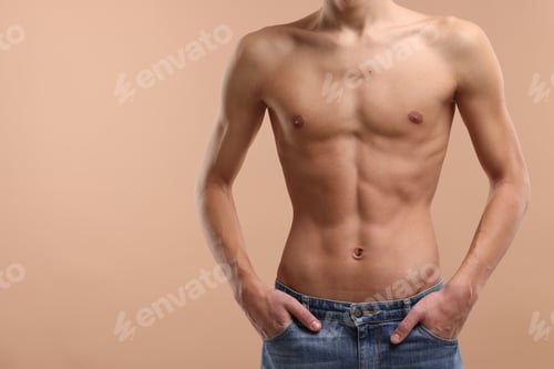 Preview: Shirtless man with slim body on beige background, closeup. Space for text