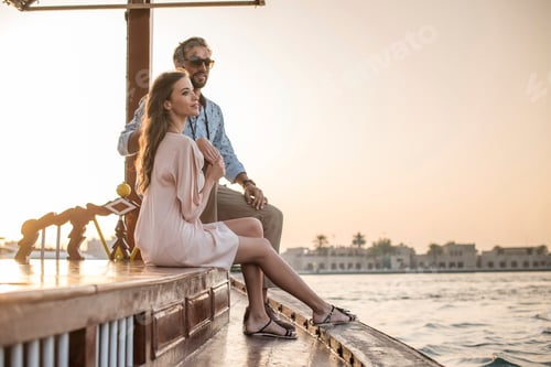Preview: Romantic couple watching from boat at Dubai marina, United Arab Emirates