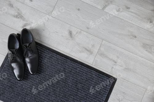 Preview: Door mat and shoes on floor, top view. Space for text