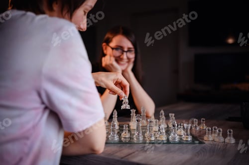 Preview: Friends Enjoying a Lighthearted Chess Game Indoors