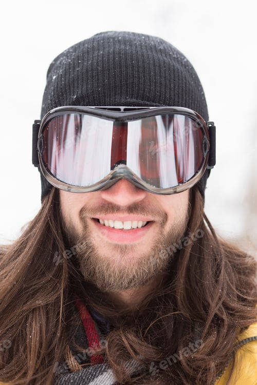 Preview: Close up portrait of smiling male snowboarder on street