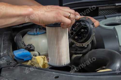 Preview: Technician changes car filter, car spare part. Car service concept.