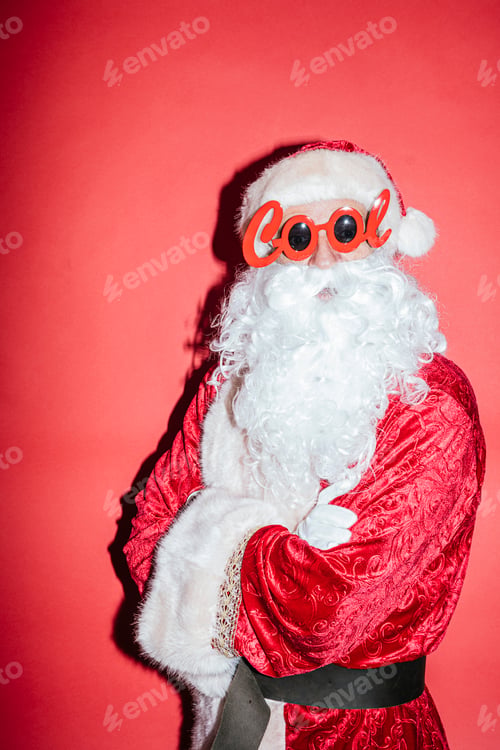 Preview: Man dressed as Santa Claus gesturing with funny glasses