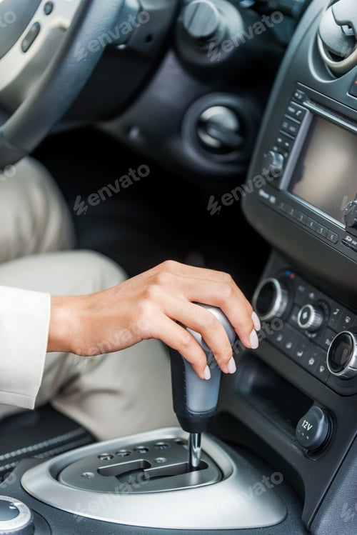 Preview: Driving a car. Close-up of woman in formalwear driving car