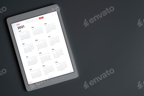 Preview: a tablet with an open calendar for 2021 year on a dark gray background. space for text