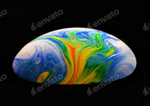Preview: Close-up shot of a rainbow soap bubble in a dark background.