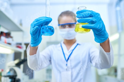 Preview: Female Scientist Holding Beakers