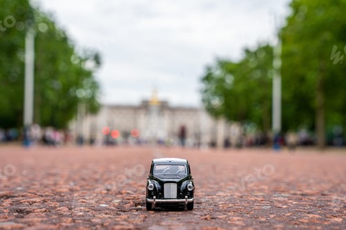 Preview: Closeup shot of a traditional black cab driving through the most famous landmarks in London
