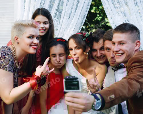Preview: group of millennial friends funny posing in camera go pro at wedding