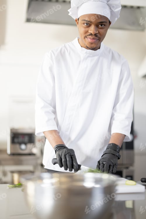 Preview: Portrait of Latin-American chef cook in the restaurant kitchen