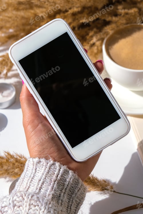 Preview: Pampas grass and white cup with coffee. Mobile phone with black screen. Checking social media Drinki