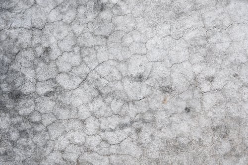 Preview: Cracked concrete wall covered with gray cement surface. Grey old wall with shabby damaged plaster or