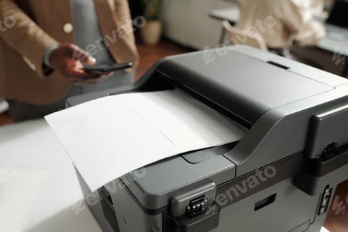 Preview: Plastic grey xerox machine with paper document on tray standing on desk