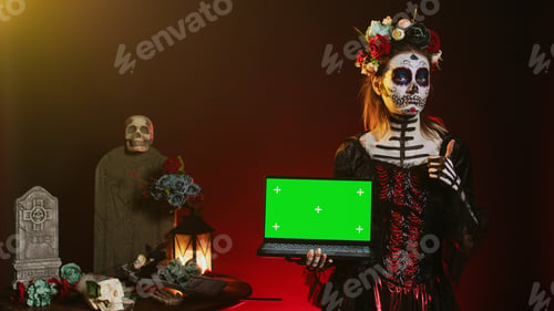 Preview: Lady of dead holding laptop with greenscreen