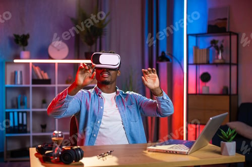Preview: Young black guy in VR goggles working in augmented reality