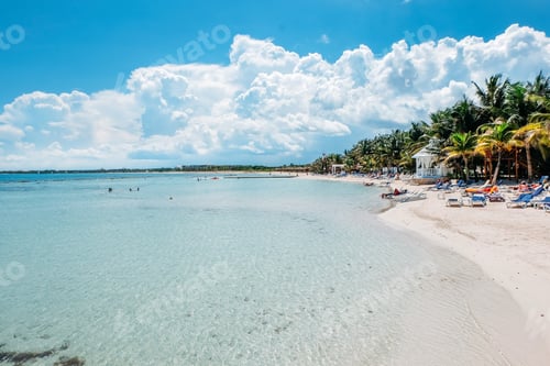 Tropical Beach View with Turquoise Water and Clouds