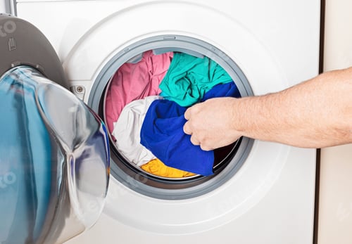 Preview: Washing or drying machine loaded with the laundry. Washing, spring cleaning concept