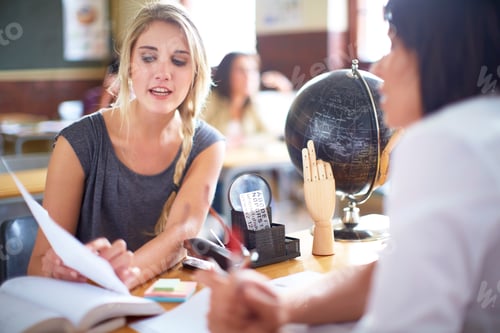 Preview: Student talking to teacher at desk