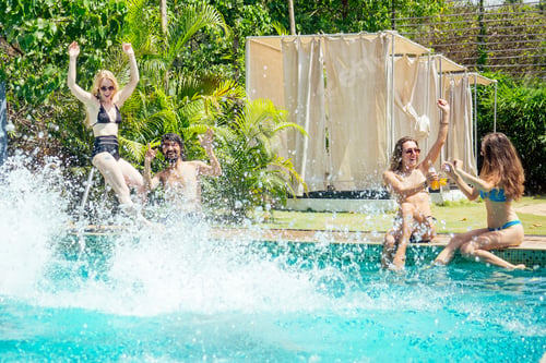 Preview: group of six friends having fun in swimmingpool outdoors
