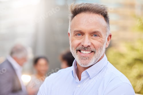 Preview: Shot of a handsome mature businessman standing outside while his colleagues stand behind him