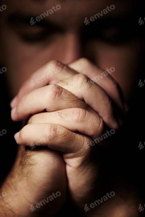 Hands Clasped Together in Somber Prayerful Meditation