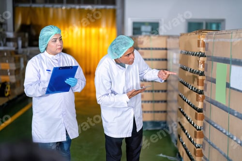 Preview: In warehouse quality control team checking drinking bottle stack on pallet before delivery