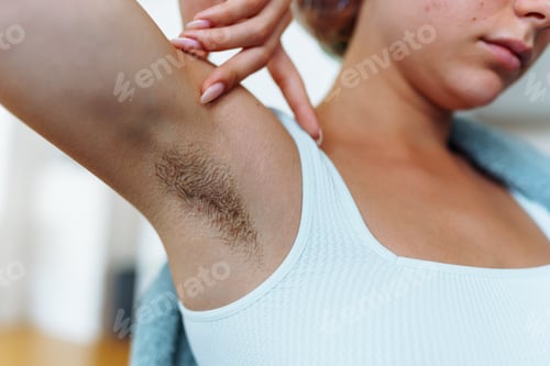 Preview: an unrecognizable young woman with unshaven armpits