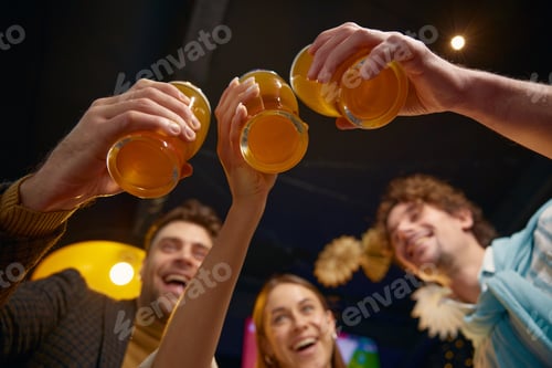 Preview: Friends clinking glasses celebrating victory of soccer team in match