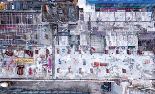 Preview: Aerial view of busy industrial construction site workers working. Development high rise building.