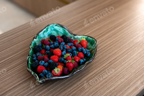 Preview: Designer plate with fresh raspberries, blackberries, blueberries, strawberries on a bed. Healthy
