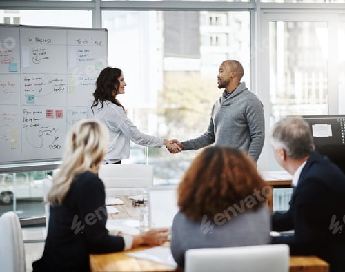 Preview: Together is how well get it done. Shot of two businesspeople shaking hands in an office.