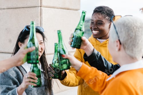 Preview: Happy millennial friends drinking together outdoors