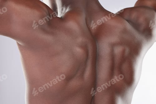 Preview: Cropped shot of an unrecognisable man standing alone in the studio and posing shirtless