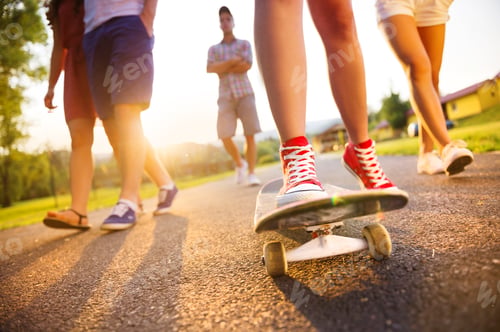 Preview: Young peoples legs with skateboard
