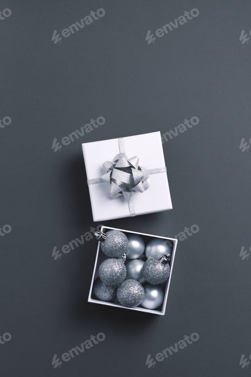Preview: Open gift box with Christmas decorations on grey background.