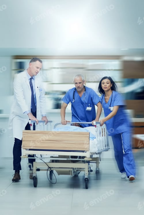 Preview: Shot of a group of medical professionals rushing a patient on a gurney down a hospital corridor