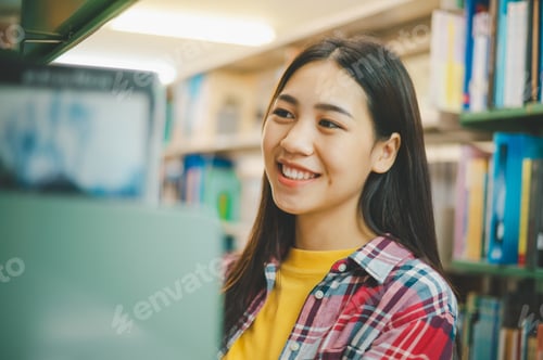 Preview: Female college students looking for books to study, make reports, find useful information